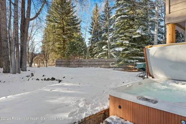 a front view of a building with lot of trees