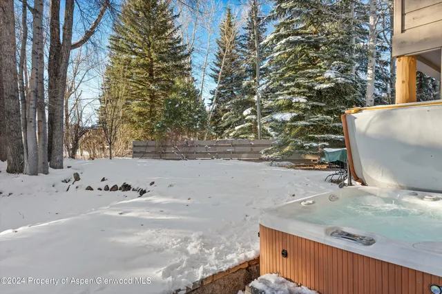 a front view of a building with lot of trees