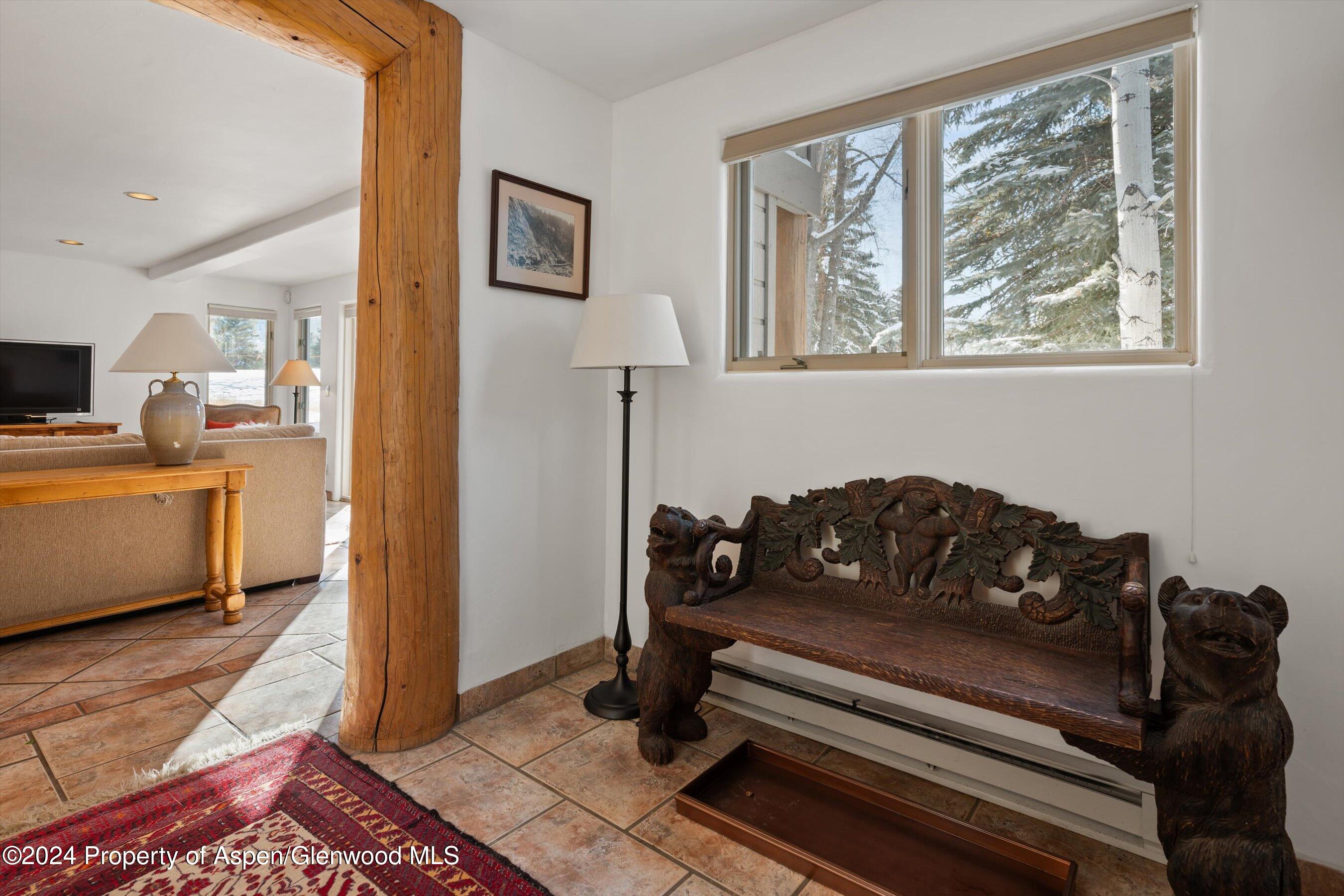 825 Cemetery Lane, Unit 2 Aspen, CO 81611 - Photo 45 of 47 a living room with a couch and a dresser next to a window