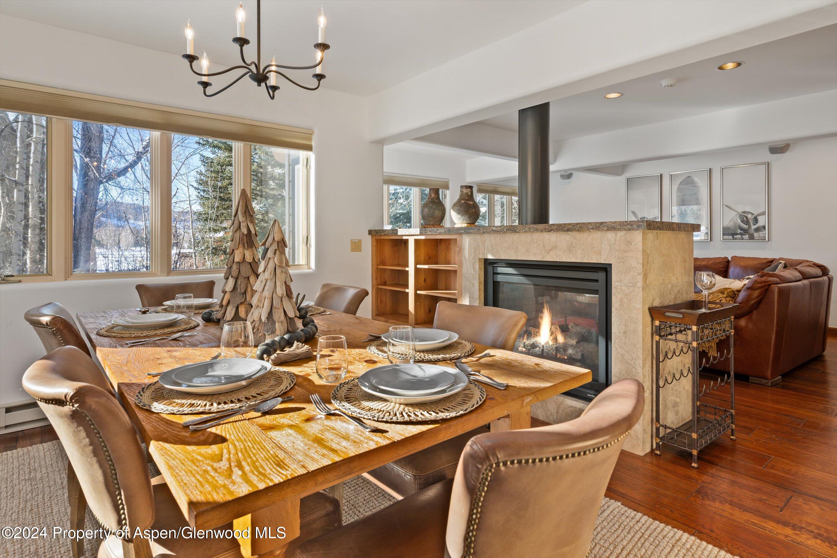 825 Cemetery Lane, Unit 2 Aspen, CO 81611 - Photo 8 of 47 a dining room with furniture a fireplace and wooden floor
