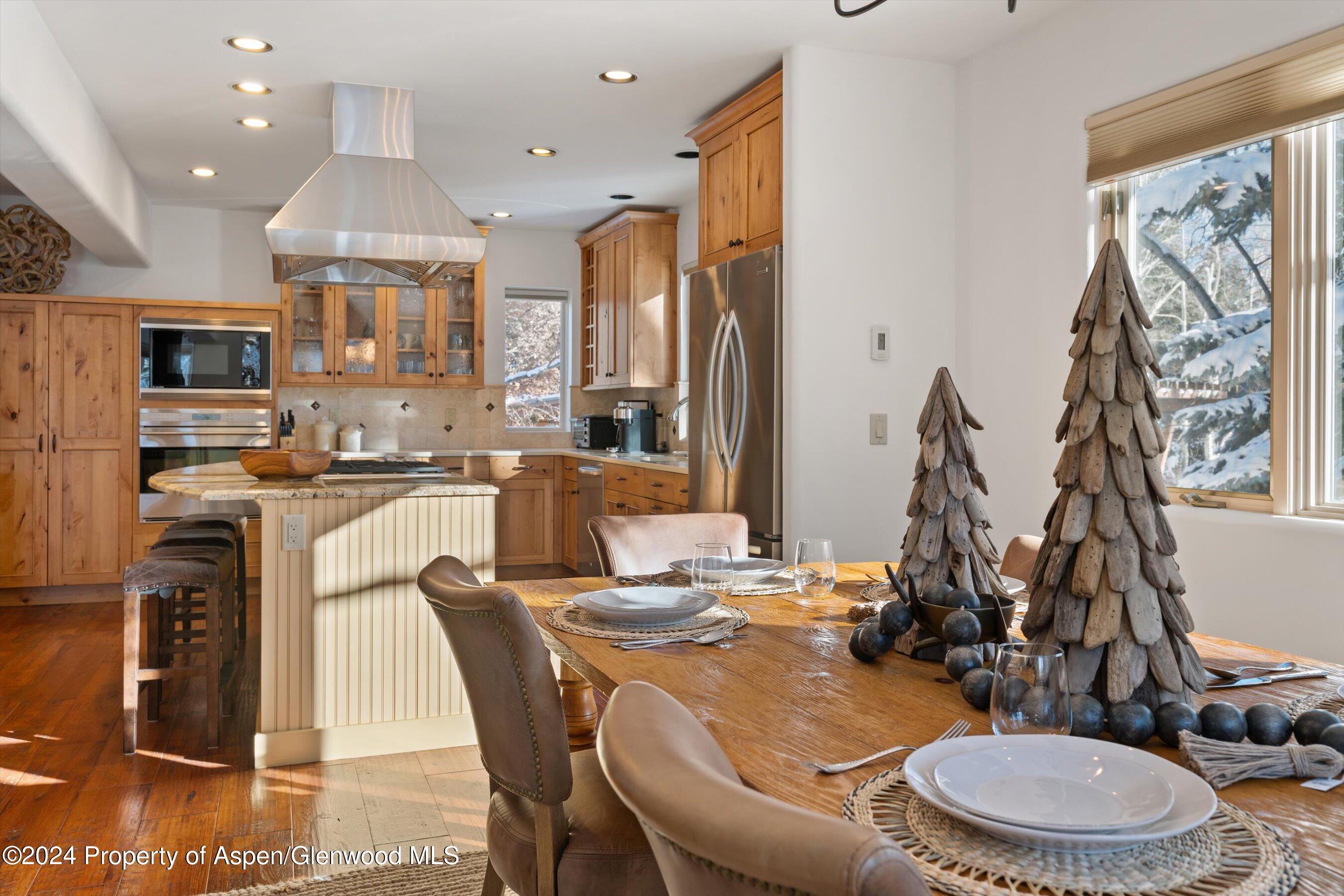 825 Cemetery Lane, Unit 2 Aspen, CO 81611 - Photo 10 of 47 a dining room with stainless steel appliances a dining table and chairs