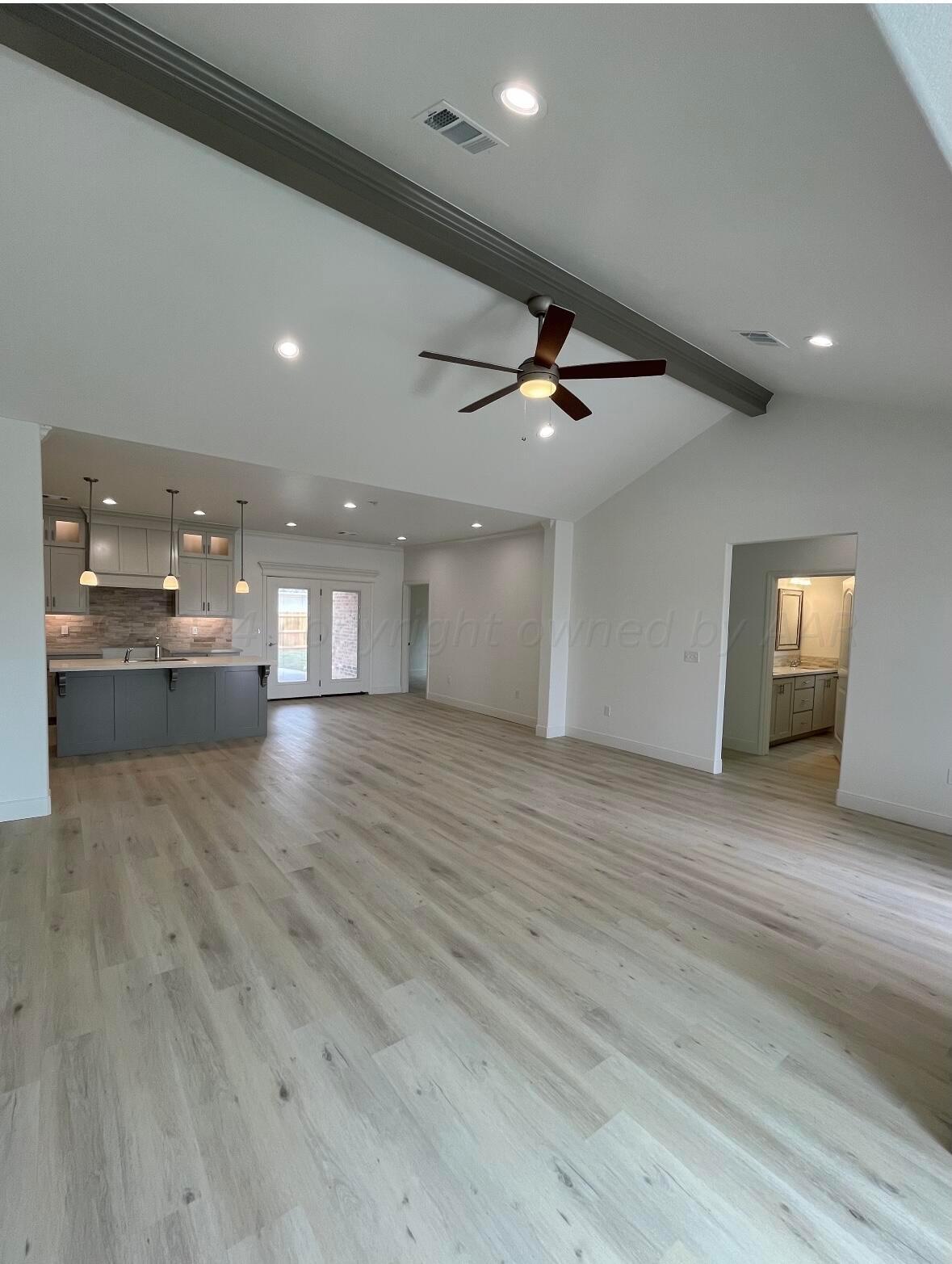 7510 Bluestone Drive Amarillo, TX 79119 - Photo 3 of 4 a view of an empty room with a kitchen