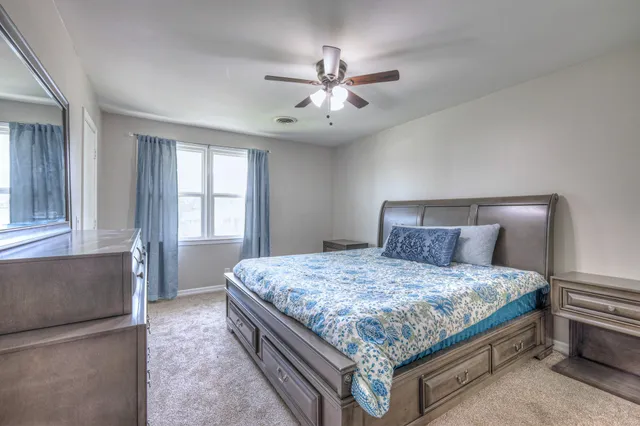 a bedroom with a bed and window