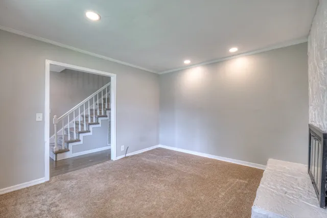 a view of an empty room with stairs