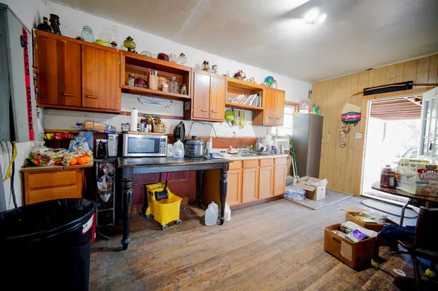a view of a porch with wooden floor and furniture