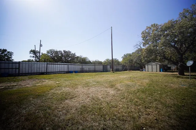 a view of wooden house and a yard