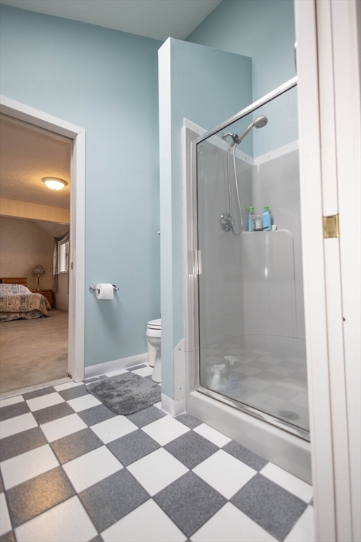10 Nancy Road Natick, MA 01760 - Photo 10 of 19 a bathroom with a glass door shower and a toilet