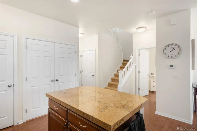 a view of hallway with washer and a clock