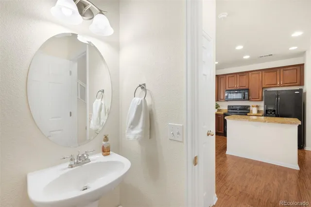 a bathroom with a sink a mirror and a shower