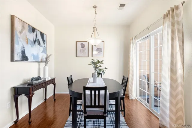 a view of a dining room with furniture window and wooden floor