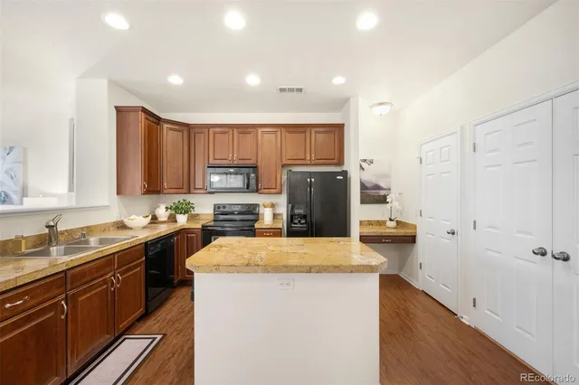 a kitchen with sink a refrigerator and cabinets