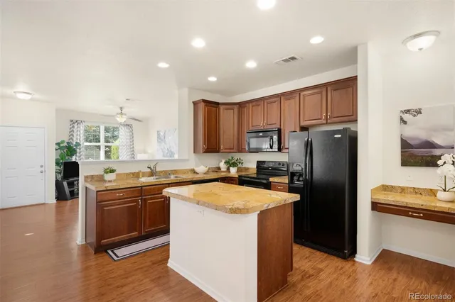 a kitchen with stainless steel appliances granite countertop a refrigerator stove microwave and sink