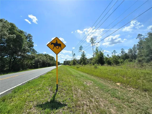 a view of a street with a big yard
