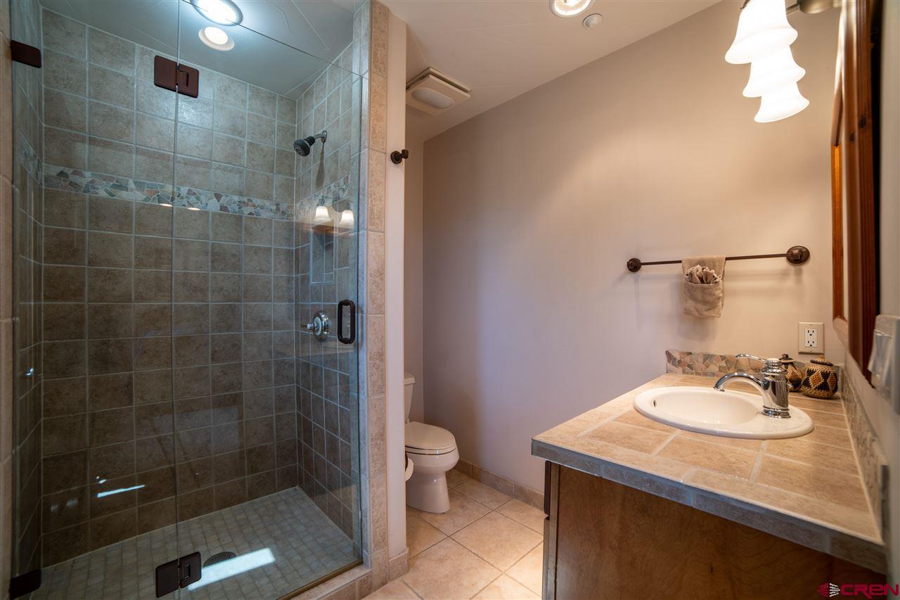 258 Goulding Creek Road Durango, CO 81301 - Photo 24 of 35 a bathroom with a sink a toilet and shower