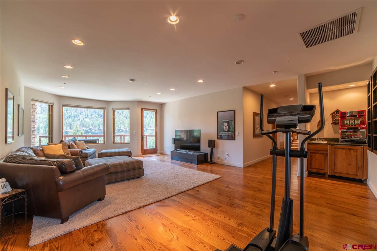 258 Goulding Creek Road Durango, CO 81301 - Photo 25 of 35 a living room with furniture and a dining table with wooden floor