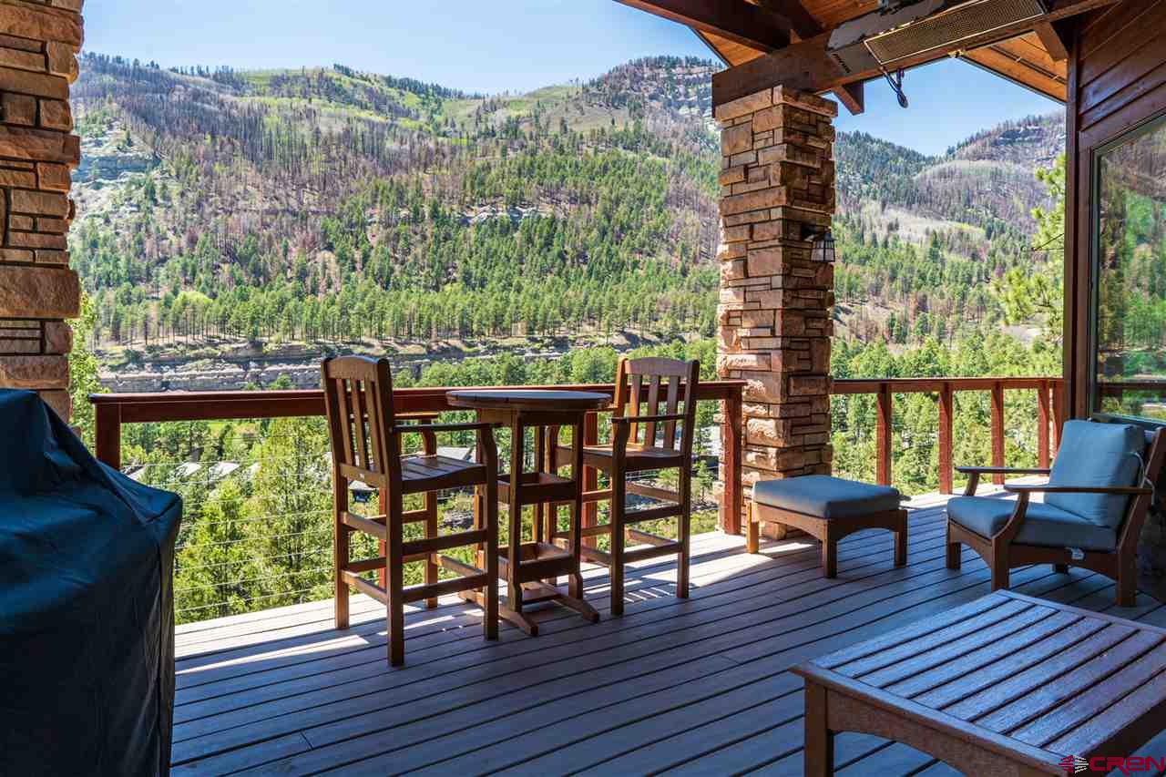 258 Goulding Creek Road Durango, CO 81301 - Photo 28 of 35 a balcony with wooden floor table and chairs