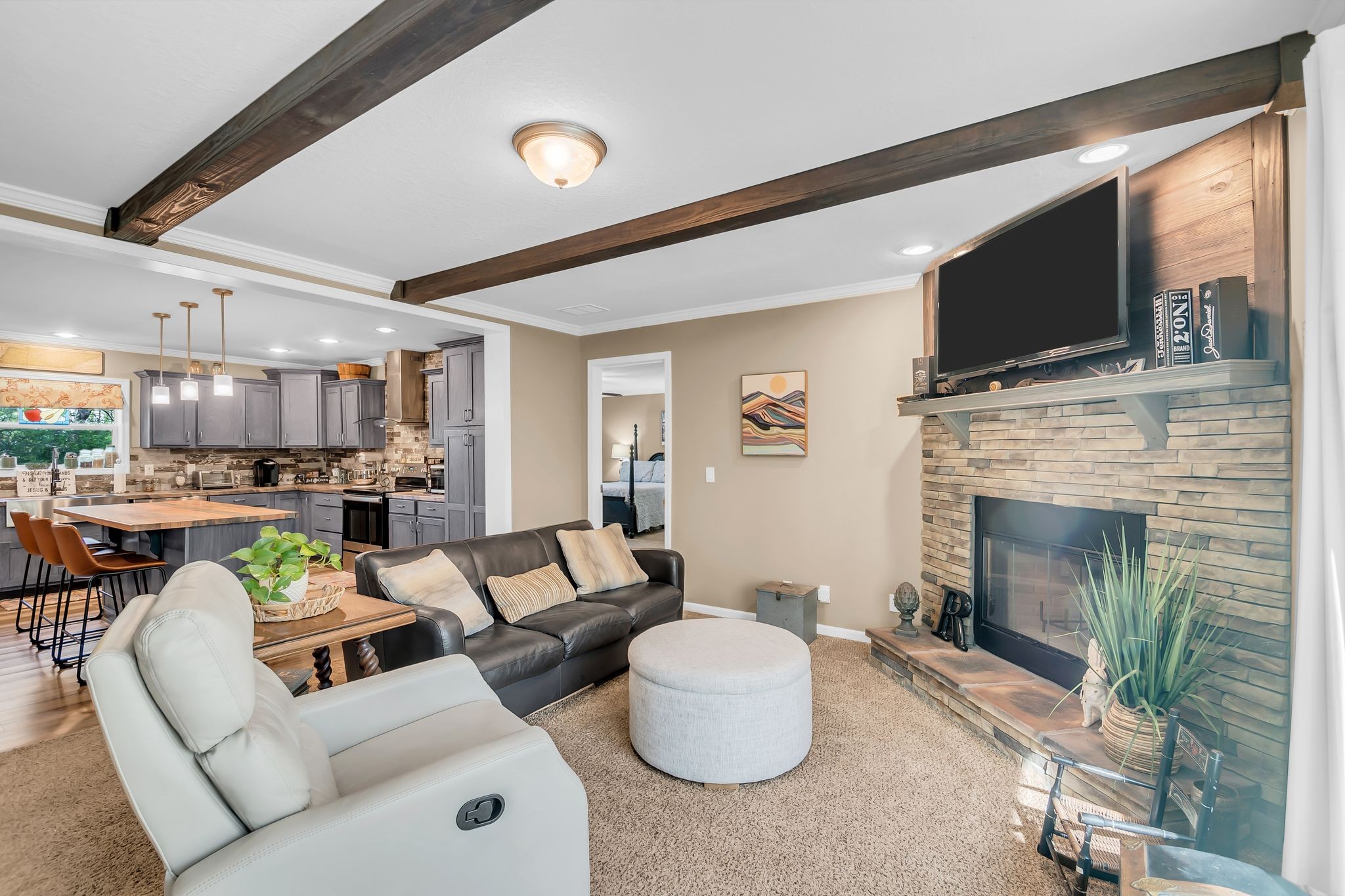 4241 Tanyard Hill Road Lynchburg, TN 37352 - Photo 16 of 50 a living room with furniture a flat screen tv and a fireplace