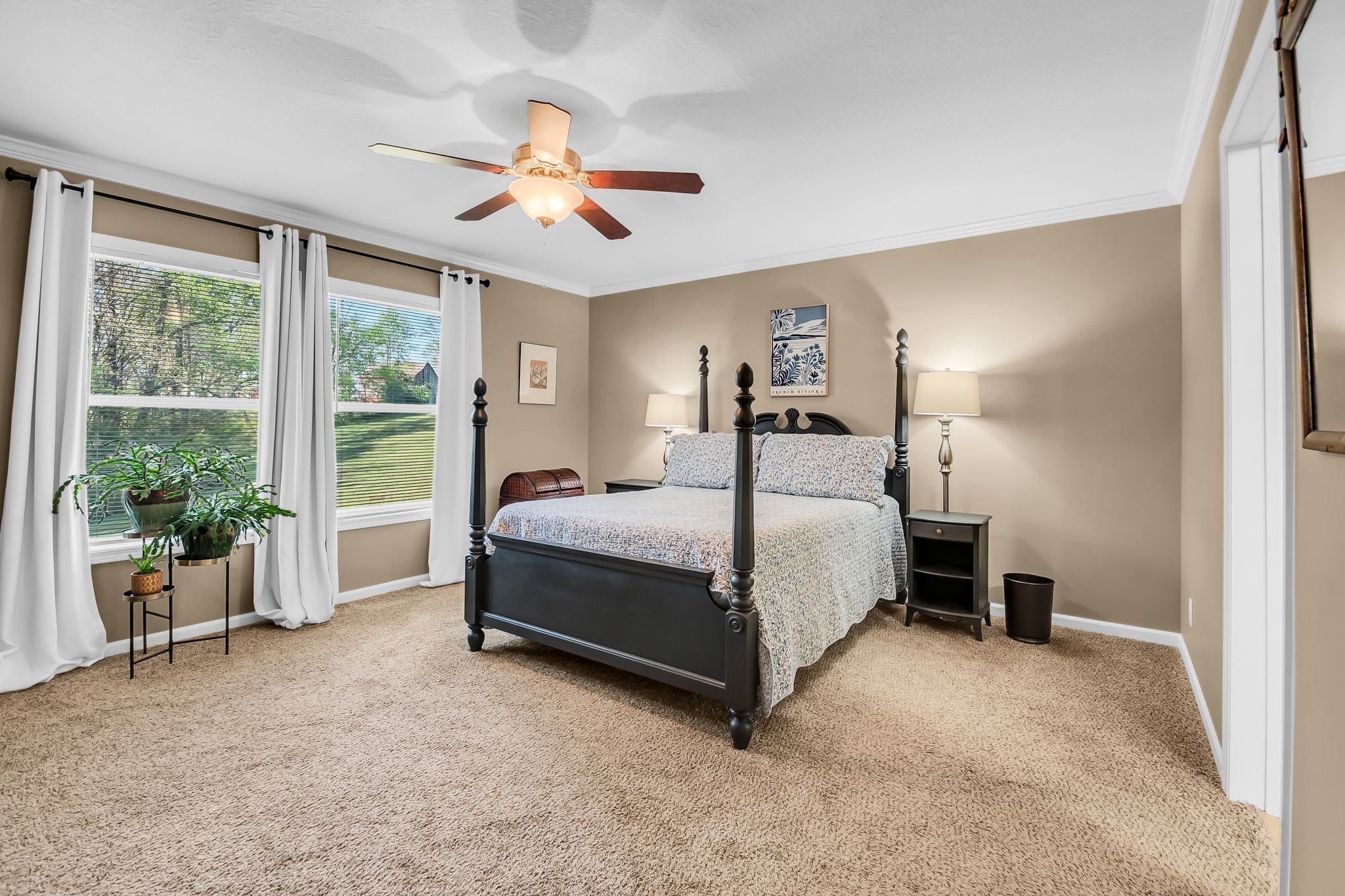 4241 Tanyard Hill Road Lynchburg, TN 37352 - Photo 18 of 50 a bedroom with a large bed and a chandelier fan