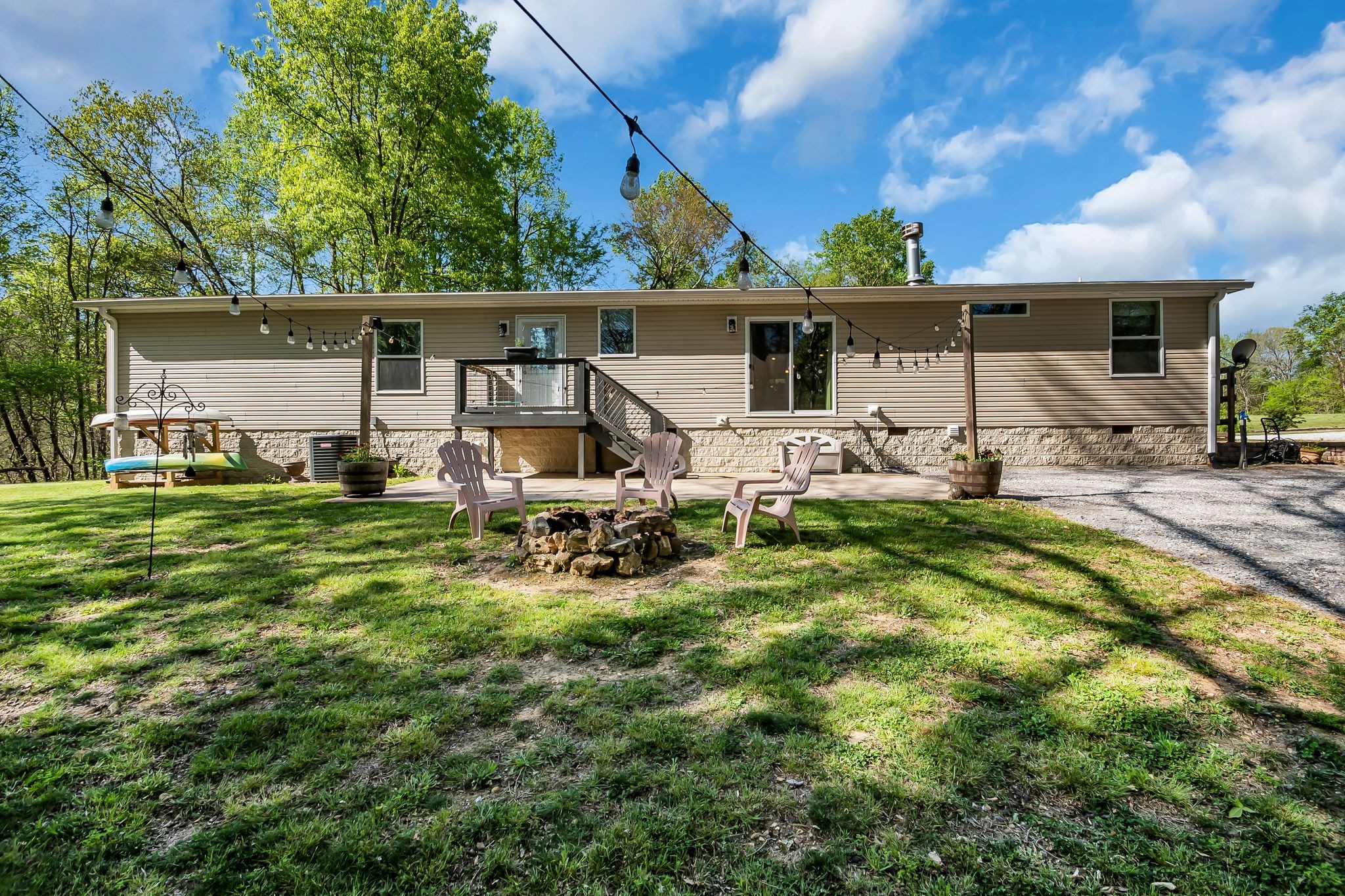 4241 Tanyard Hill Road Lynchburg, TN 37352 - Photo 33 of 50 a backyard of a house with table and chairs