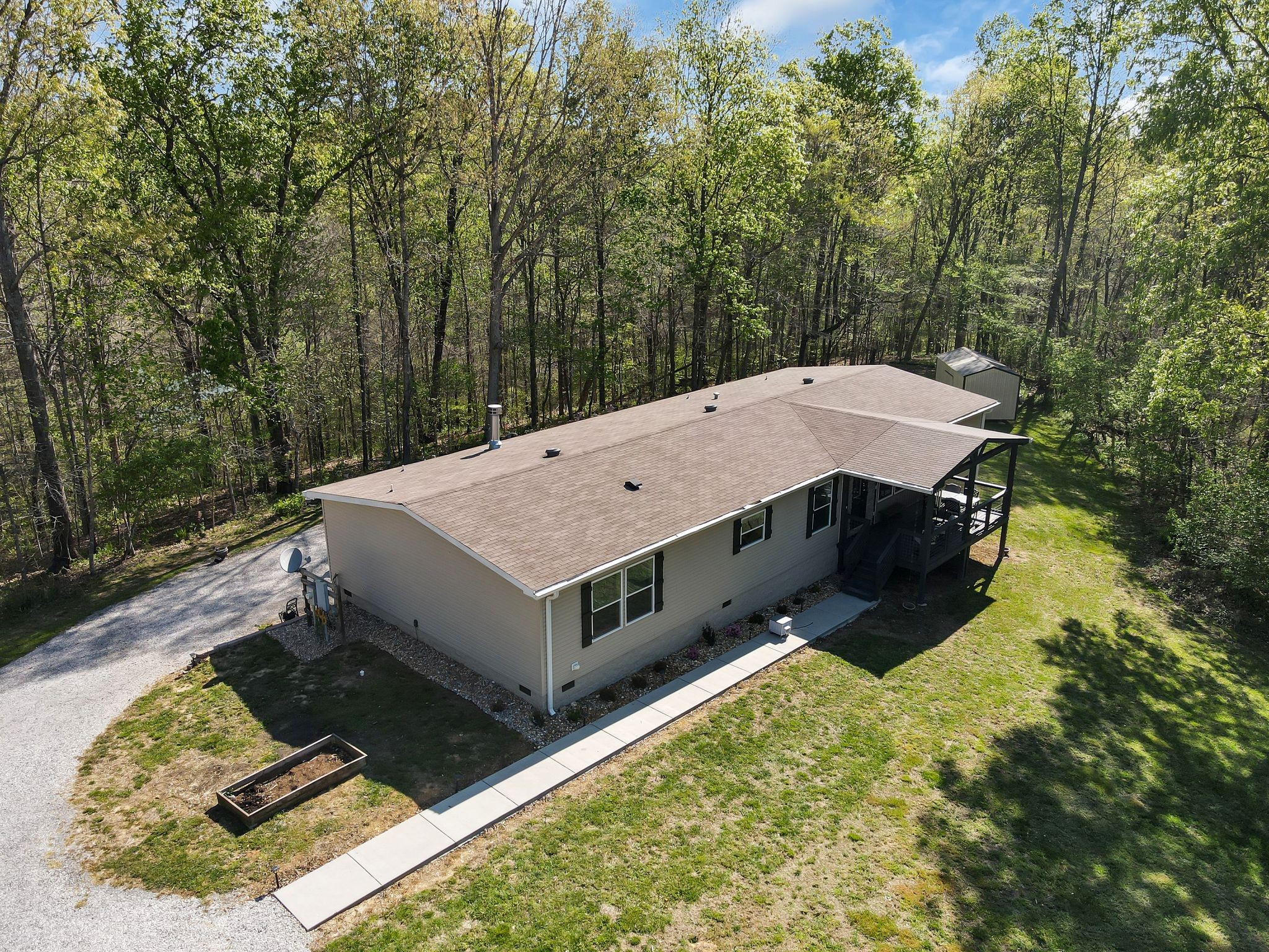 4241 Tanyard Hill Road Lynchburg, TN 37352 - Photo 38 of 50 a view of a backyard with a small deck and a garden