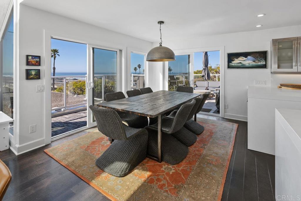 328 Shoemaker Court Solana Beach, CA 92075 - Photo 4 of 19 a dining room with furniture a chandelier and wooden floor