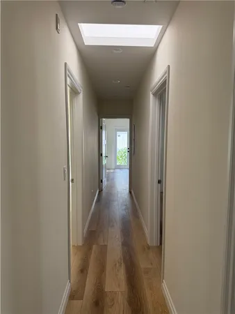a view of a hallway with wooden floor