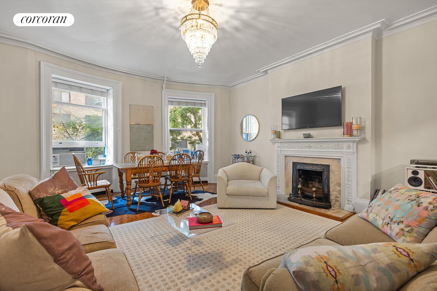 7 West 16th Street Manhattan, NY 10011 - Photo 3 of 21 a living room with furniture a fireplace and a flat screen tv