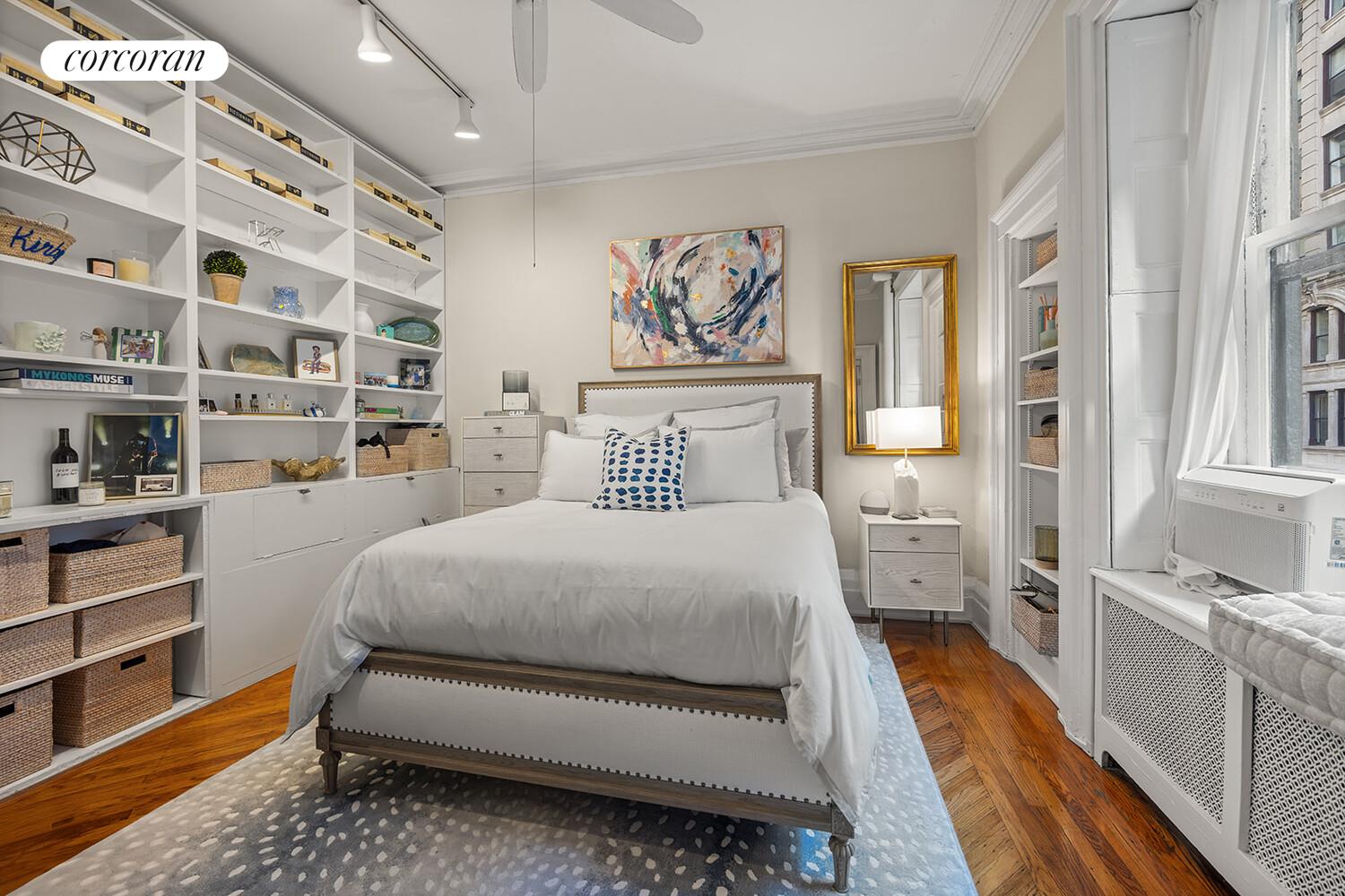 7 West 16th Street Manhattan, NY 10011 - Photo 5 of 21 a bedroom with a bed and a book shelf