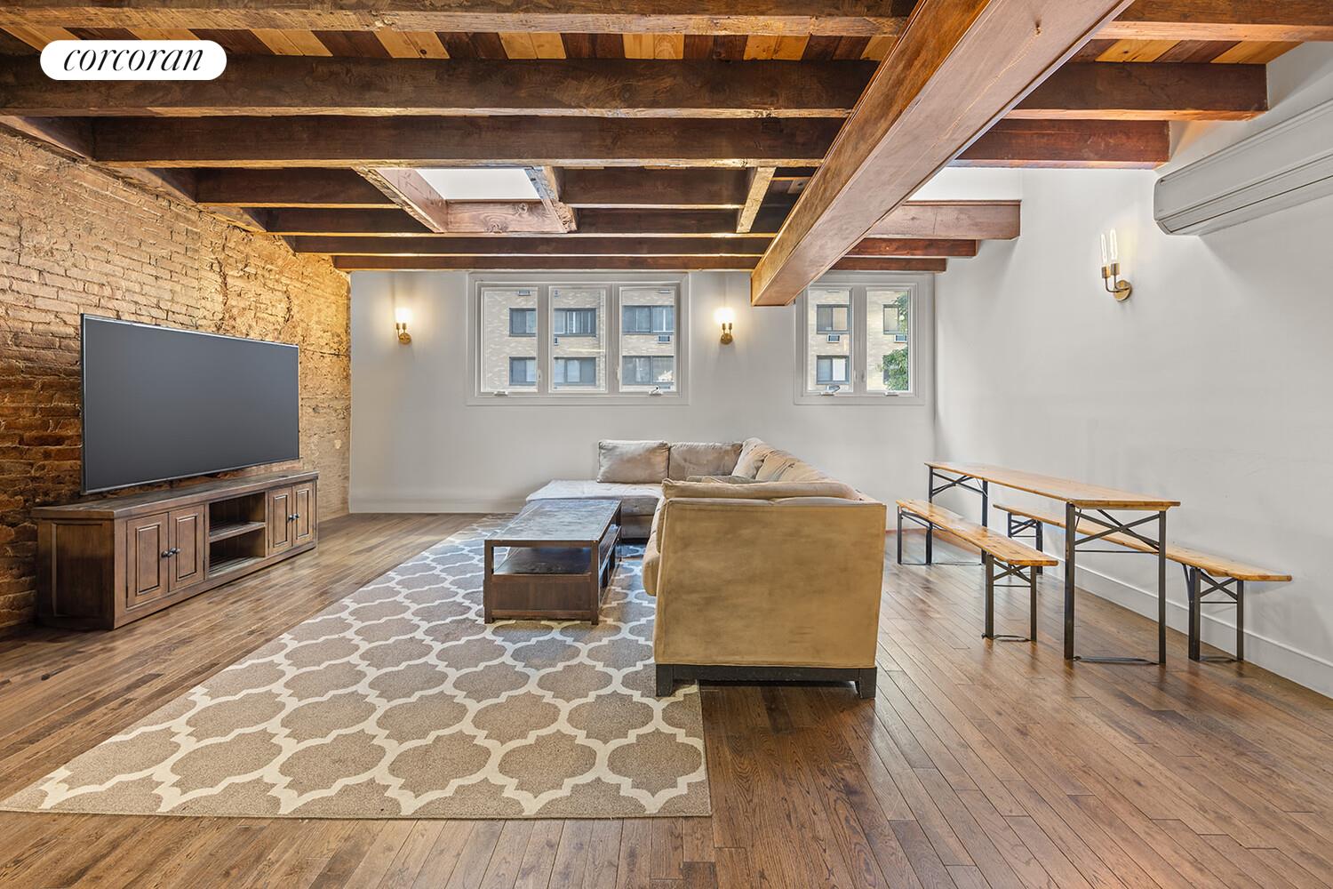 7 West 16th Street Manhattan, NY 10011 - Photo 8 of 21 a living room with furniture and a flat screen tv