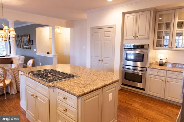 a kitchen with stainless steel appliances granite countertop a stove and a refrigerator
