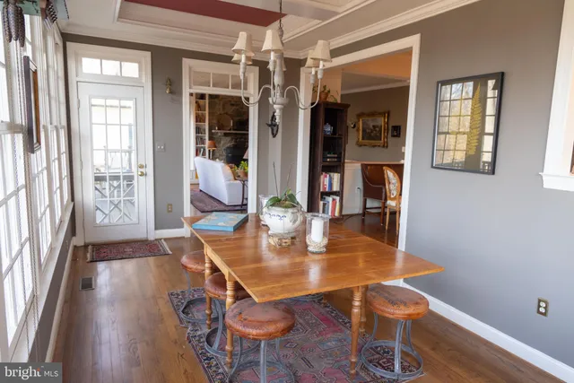 a dining room with furniture and wooden floor
