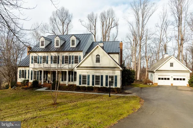 a view of a large white house with a large pool