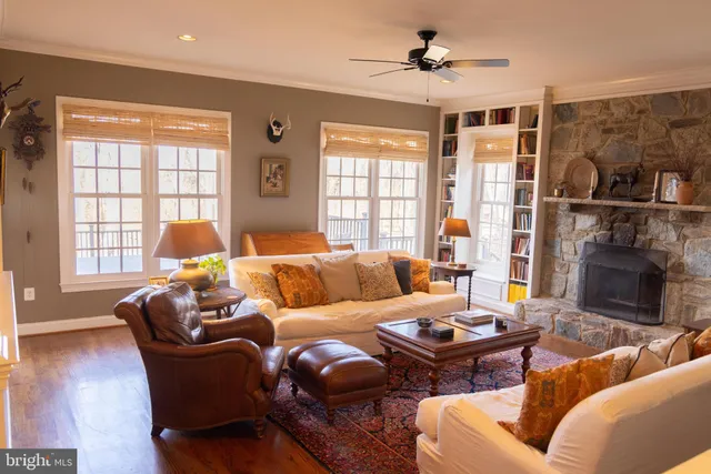 a living room with furniture a fireplace and a window