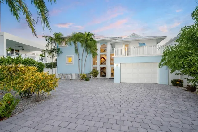 a front view of a house with a yard and a garage