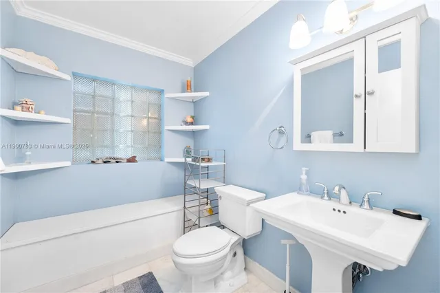 a bathroom with a sink toilet and mirror