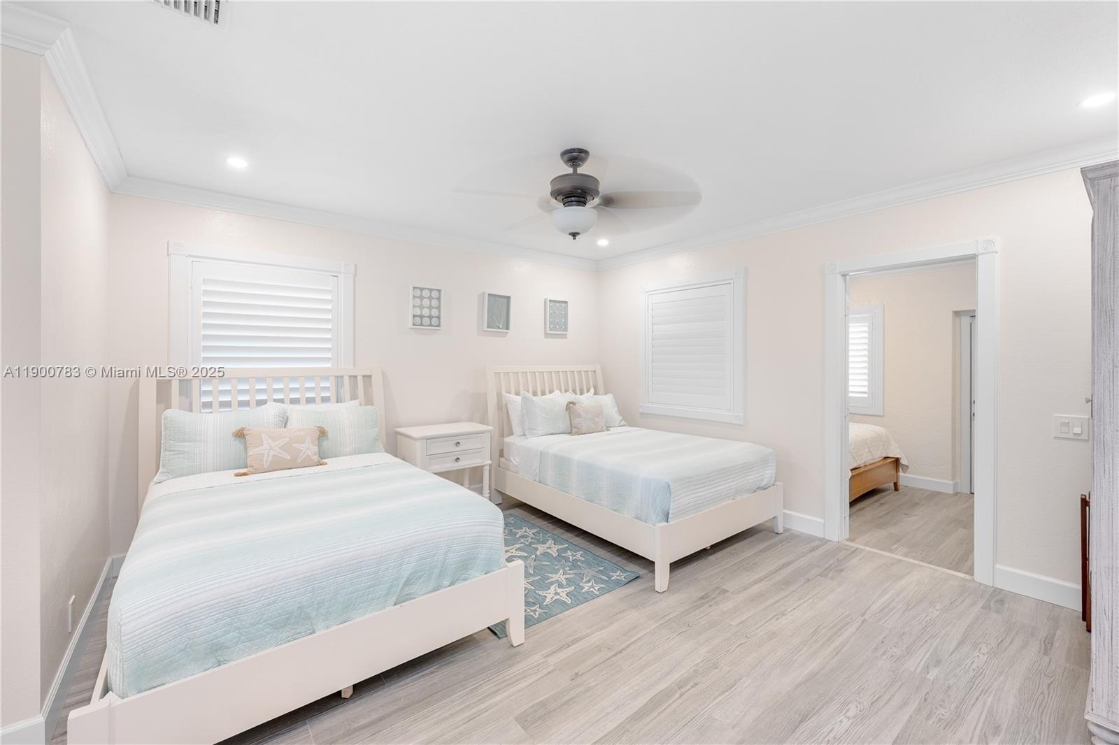 111 Spoonbill Road Tavernier, FL 33070 - Photo 18 of 39 a bedroom with two beds and painting on the wall