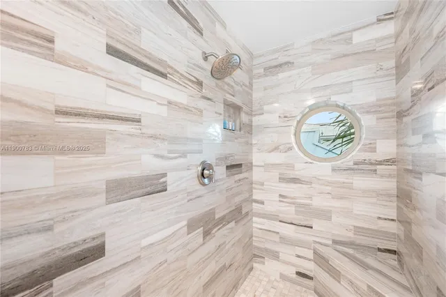 a bathroom with a bathtub and a shower