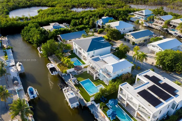 an aerial view of a house with a ocean view