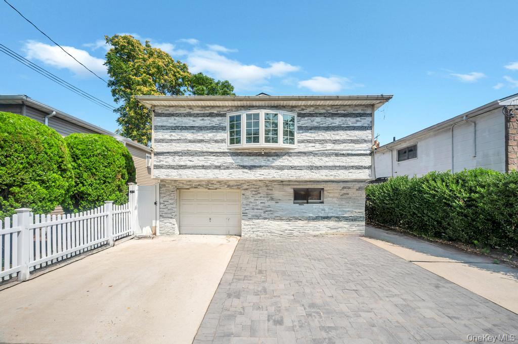 30 Sutton Street Hempstead, NY 11550 - Photo 1 of 1 a front view of a house with a yard