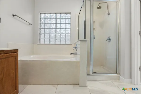a bathroom with a bathtub and shower