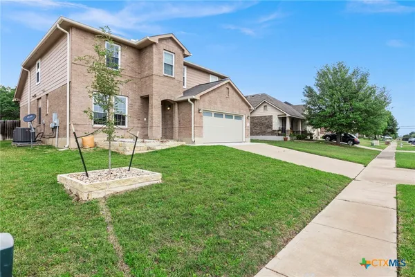 a front view of a house with a yard