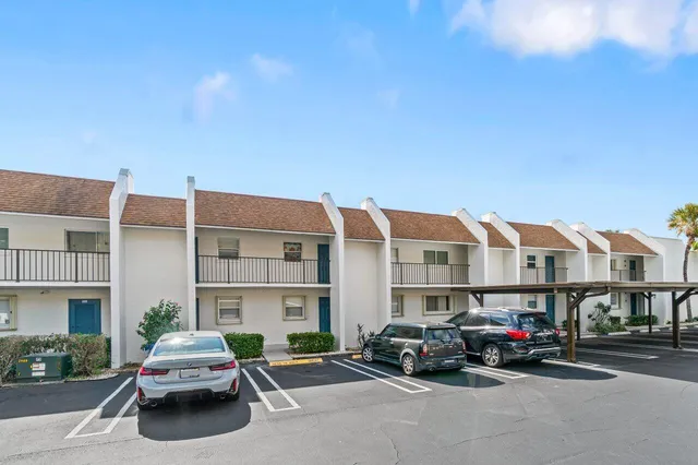 a car parked in front of a big building