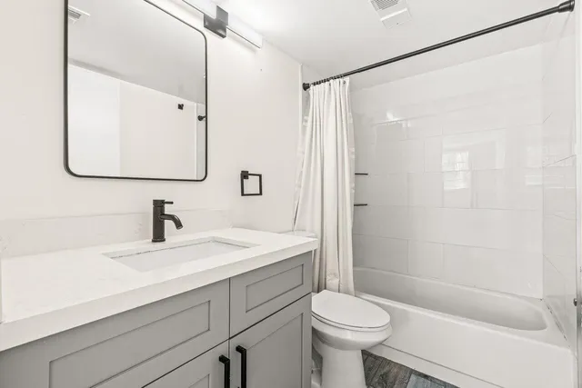 a bathroom with a sink toilet and shower