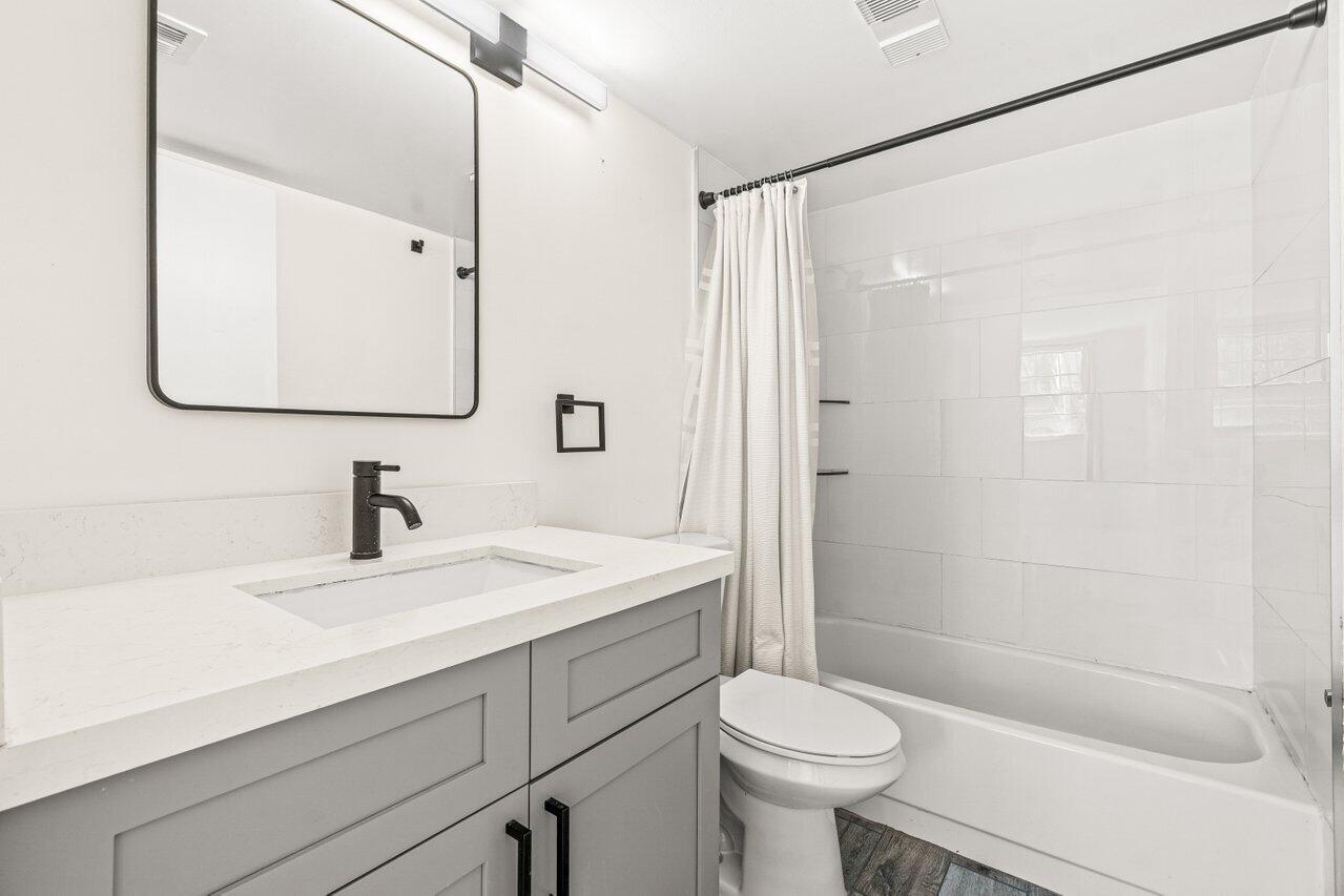 2935 Southwest 22nd Avenue, Unit 1060 Delray Beach, FL 33445 - Photo 13 of 21 a bathroom with a sink toilet and shower