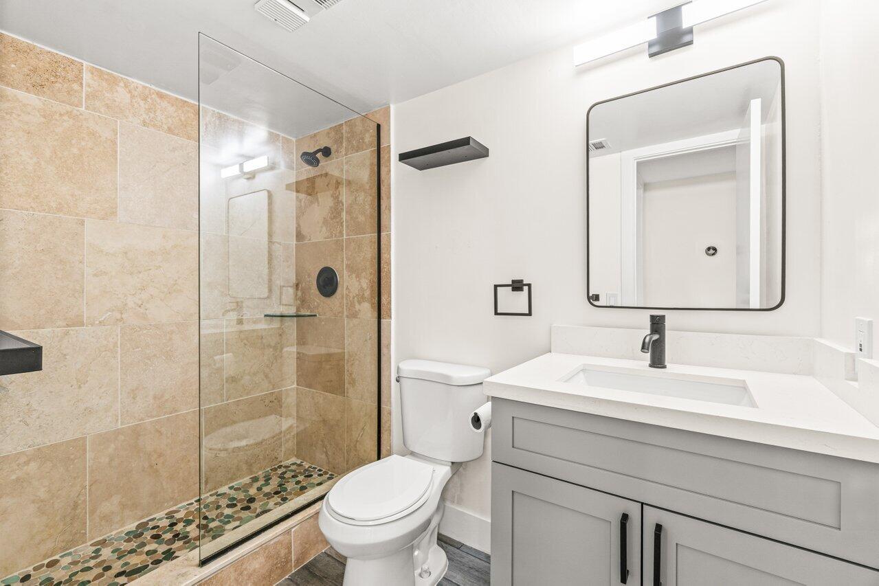 2935 Southwest 22nd Avenue, Unit 1060 Delray Beach, FL 33445 - Photo 17 of 21 a bathroom with a sink toilet and shower