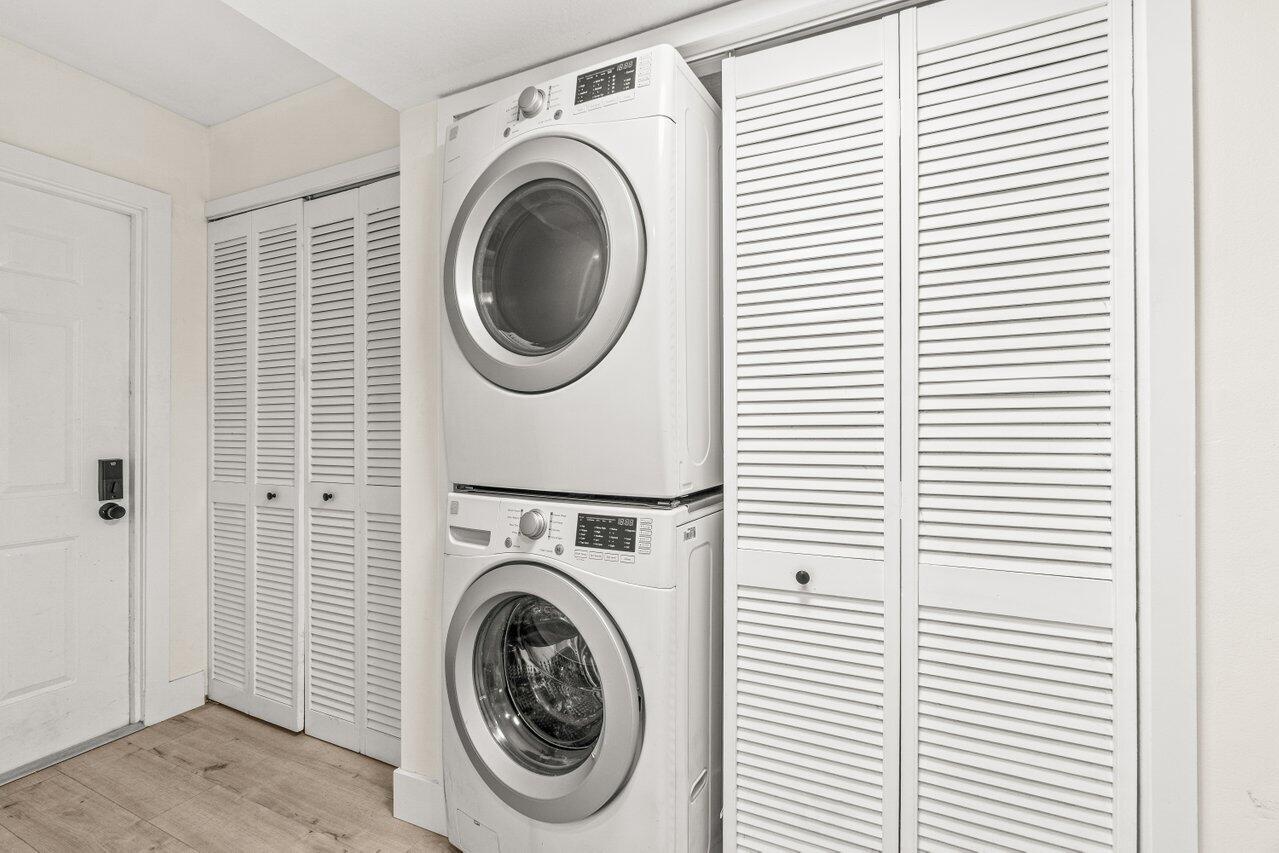 2935 Southwest 22nd Avenue, Unit 1060 Delray Beach, FL 33445 - Photo 18 of 21 a view of a hallway with washer and dryer