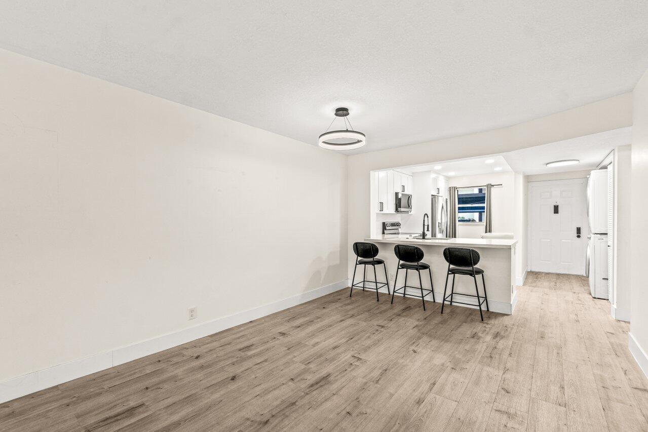2935 Southwest 22nd Avenue, Unit 1060 Delray Beach, FL 33445 - Photo 6 of 21 a view of a livingroom with furniture and wooden floor
