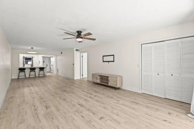 a view of livingroom with hardwood floor and a ceiling fan