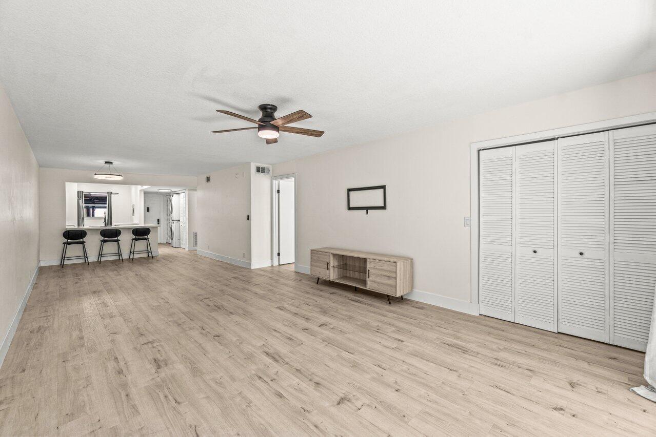 2935 Southwest 22nd Avenue, Unit 1060 Delray Beach, FL 33445 - Photo 7 of 21 a view of livingroom with hardwood floor and a ceiling fan