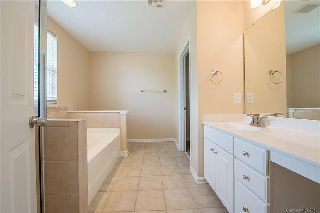 161 Snead Road Fort Mill, SC 29715 - Photo 3 of 14 a spacious bathroom with a double vanity sink a mirror and a bathtub